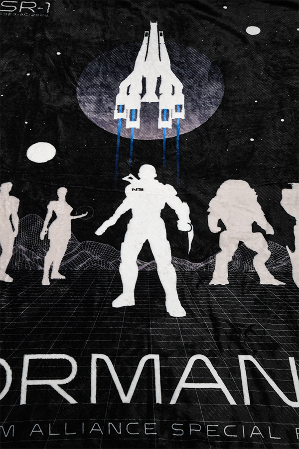 Image shows Mass Effect Team Throw Blanket zoomed in at Commander Shepard's silhouette. Commander Shepard is the main protagonist of Mass Effect, Mass Effect 2, and Mass Effect 3, whose gender, appearance, skills and pre-service history are all customizable and have impacts on the story. Shepard's first name is also customizable,