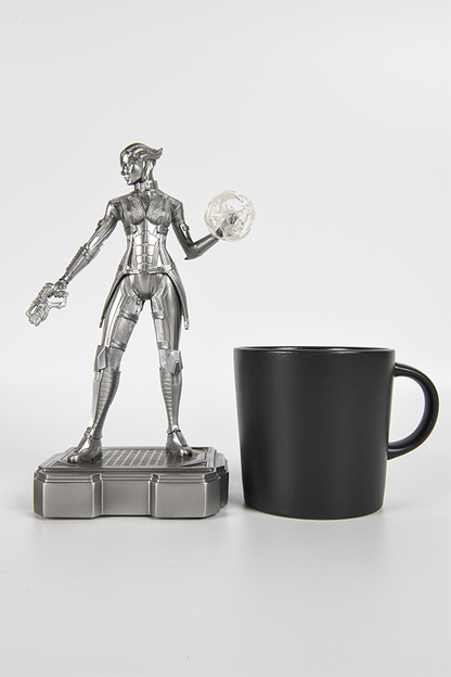 Image shows Liara T'Soni Silver Edition Statue facing front with a mug beside it for scale. The only child of Matriarch Benezia, Liara was raised by her mother alone. She knew little of who her father was, only that it was another asari. Liara is a pureblood, a fact she speculates to be a reason why her "father" seemingly did not wish to be identified.