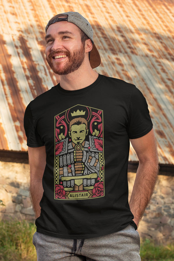 Image shows Dragon Age Alistair Portrait Tee worn by male model facing front at an angle. Product features side seams and a tear away label. 