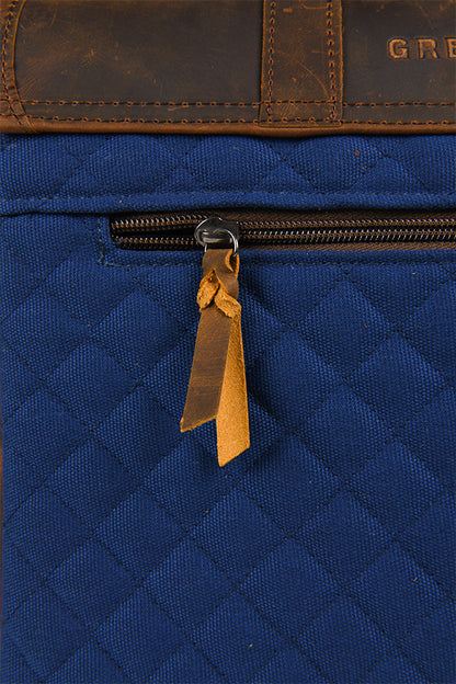 Detail shot of the zipper on the back pocket, showing a small strip of leather tied to it.