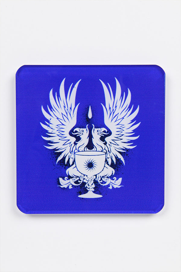 Image shows the coaster with the Grey Wardens heraldry symbol.   The symbol is white showing two griffons with a chalice infront over a blue background.