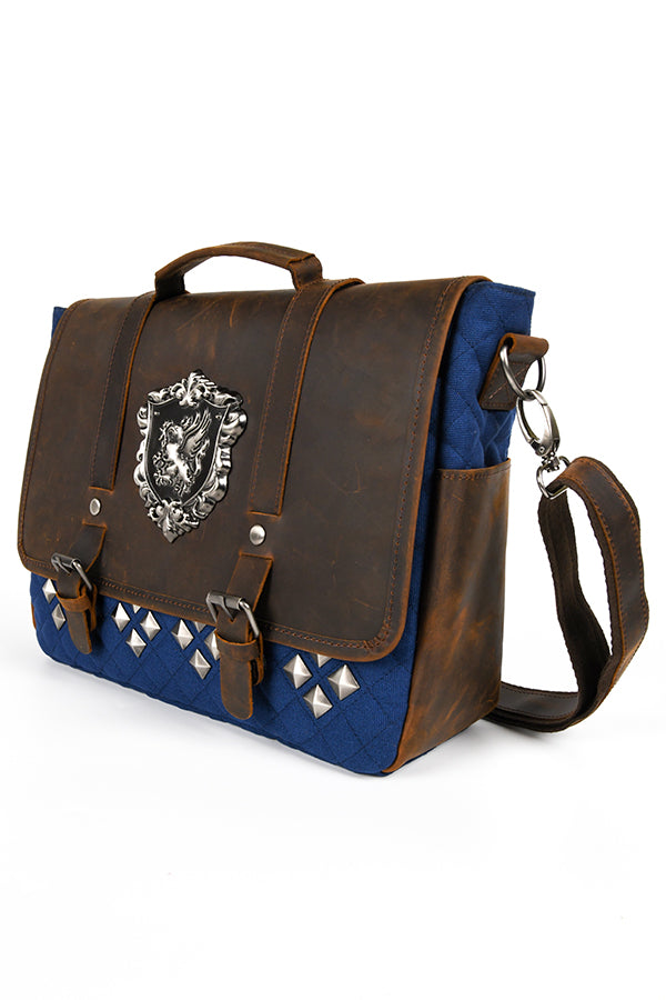 Image of the front of the Dragon Age Grey Warden Leather Bag in three-quarter view facing left, showing one of two leather side pockets.