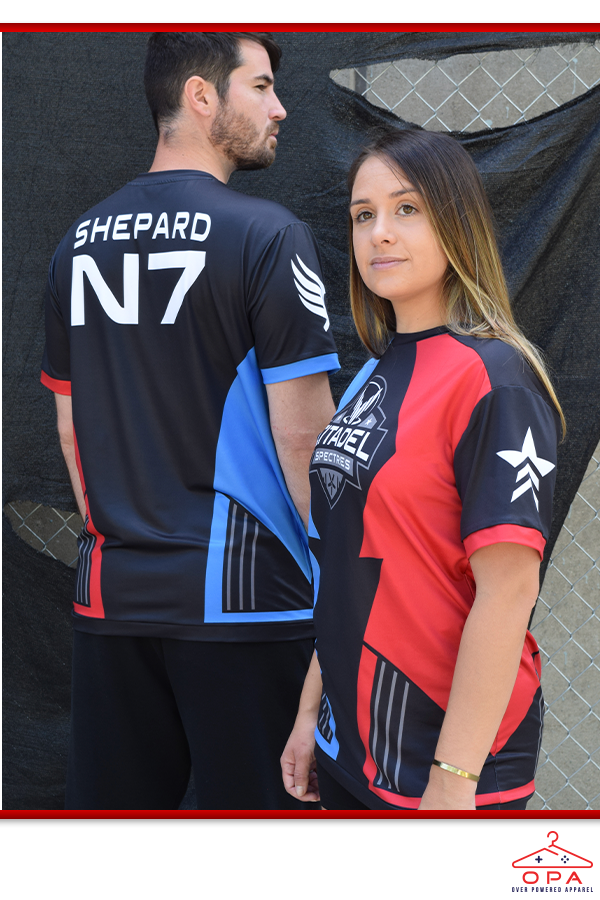 Image shows Mass Effect eSport OPA Jersey worn by male and female model from 2 different angles. Product is made with 92% Polyester and 8% spandex and features a black, red, and blue print.