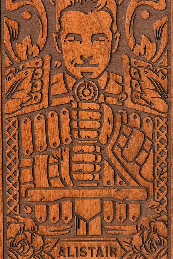 Image shows the wooden box facing front with the carved Alistair design zoomed in.