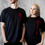 Image shows Mass Effect True Renegade OPA Tee worn by both male and female model facing at an angle.