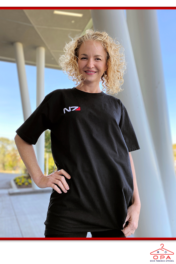 Image shows Mass Effect N7 3D Embroidered OPA T-Shirt worn by female model facing front.