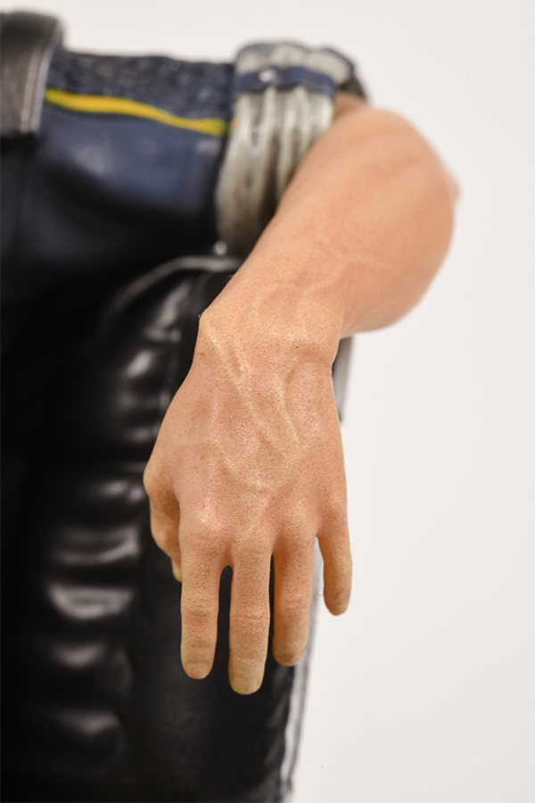 Image shows Mass Effect Kaidan Alenko Statue's left arm zoomed in while resting in an arm chair. 
