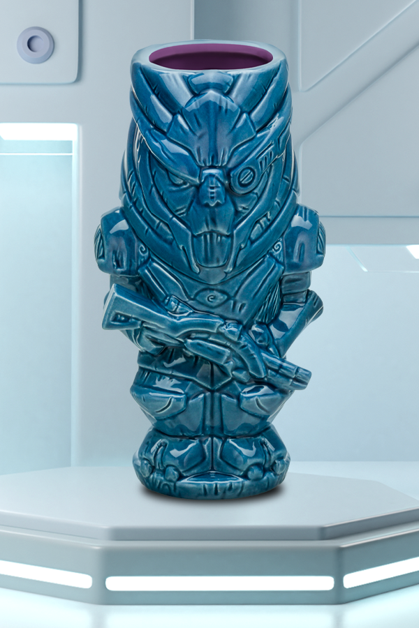 Image shows Mass Effect Garrus Geeki Tiki Mug facing front. Product has a blue glaze exterior with purple interiors. Product's capacity is 18 oz. This ceramic sculpted mug features unique detailing that stays true to traditional tiki culture and the character. The mug adds a nice touch while serving Nui Nui, Piña Coladas and other Tiki classics.