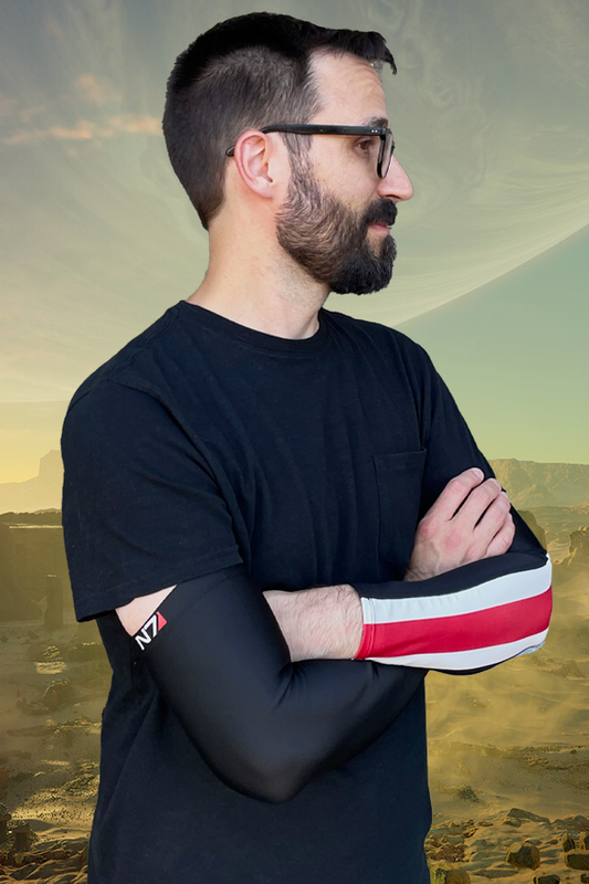 Image shows Mass Effect N7 Performance Sleeves worn by male model. Stretchy, breathable and with just the right amount of compression, this arm sleeve relieves strain from the joints and gives your arms the support to lift, push, punch and perform like a pro.