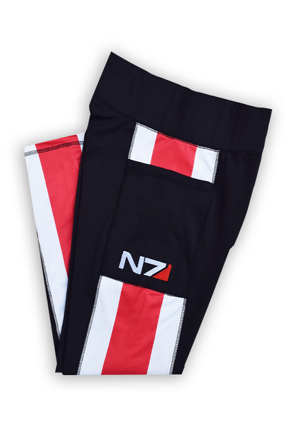 Image shows Mass Effect N7 Ankle Legging laid flat and folded. Product is a women's workout leggings and the perfect pair for squatting, running, dancing and lounging.