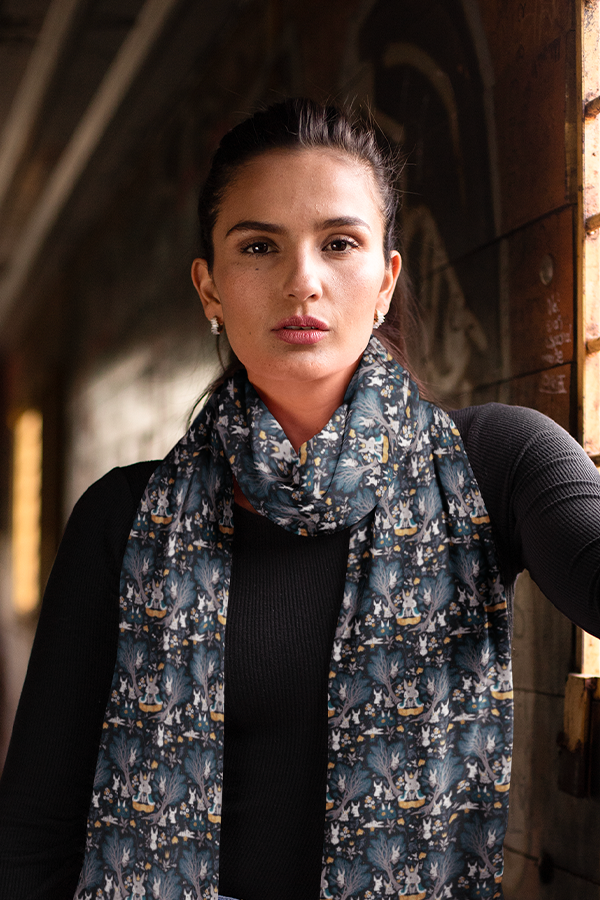 Image shows Dragon Age Nug King Scarf worn by female model facing front. Product is 70" x 12" and made with 100% Polyester. 