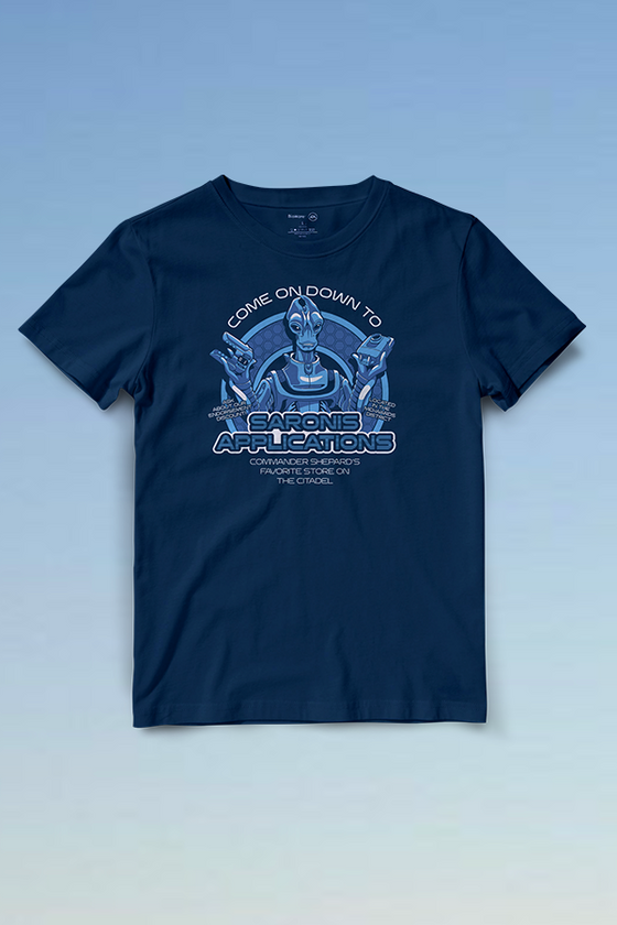 Image shows Mass Effect Saronis Applications Tee facing front. Features the picture of Marab with text in blue. Made using premium cotton fabric, this T-shirt is breathable and comes in a unisex fit. Complement it with a pair of dark jeans or joggers to complete the look.