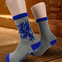 Image shows Dragon Age Grey Warden gray socks worn on mannequin feet. Product features the Grey Wardens logo and text.