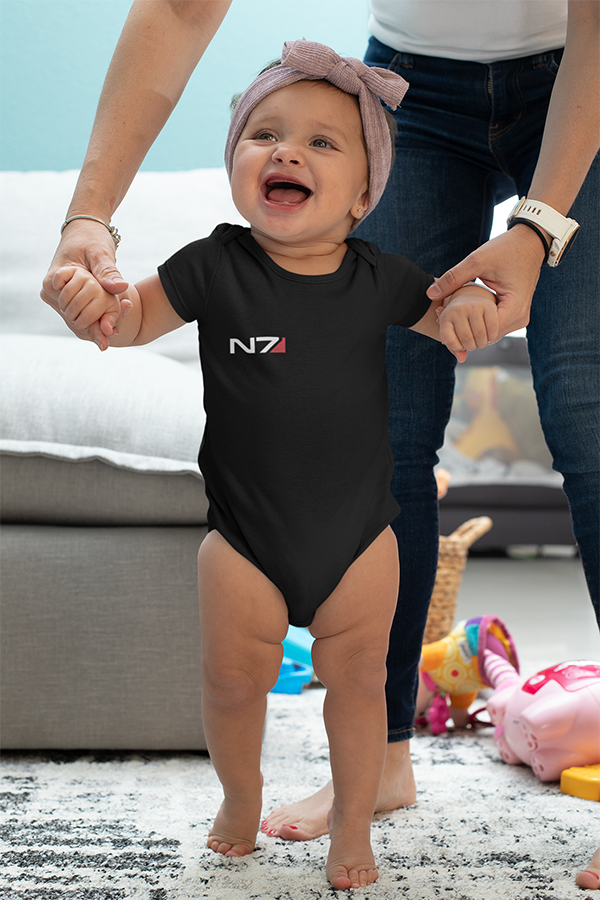 Image shows female baby model being walked while wearing the N7 I Have To Go Baby Onesie. Product features flatlock stitched seams and an innovative three-snap closure.