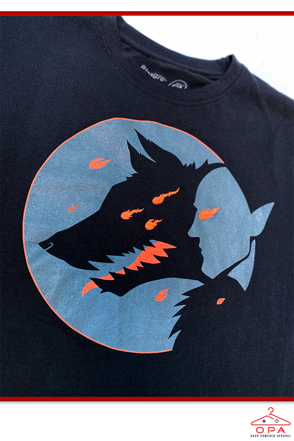 Image shows Dragon Age Dread Wolf OPA Tee with the front logo zoomed in. The logo features an oversized lunar print with the silhouette of the dread wolf and Solas.
