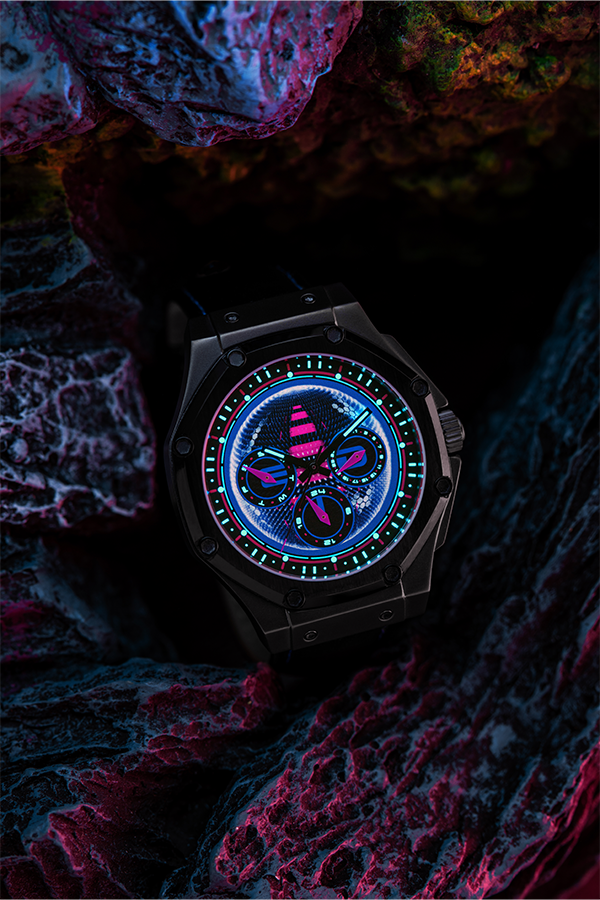 Image shows Mass Effect EDI Watch sitting on a rock formation facing front. The watch case is made with 316 Stainless Steel and lens features a scratch-resistant mineral crystal. The watch is 100 meters resistant and uses an SR battery.