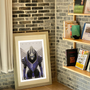Image shows Mass Effect Garrus Fine Art Print leaning on a wall facing at an angle. The artwork is a full bleed print depicting Garrus dressed up as the Archangel.