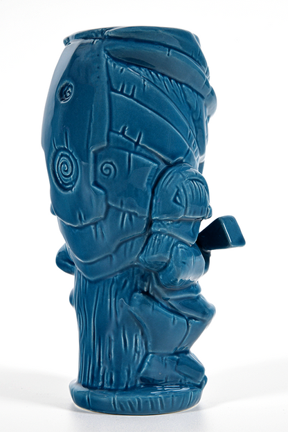 Image shows Mass Effect Garrus Geeki Tiki Mug facing back at an angle. Garrus Vakarian is a turian, formerly part of C-Sec's Investigation Division. Like most turians, Garrus had his military training at fifteen, but later followed in his father's footsteps to become a C-Sec officer. He was responsible for the investigation of Saren Arterius, the Council's top Spectre, after the Alliance claimed Saren had gone rogue