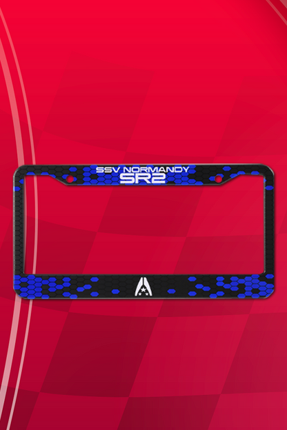 Image shows Mass Effect Normandy Auto Accessory Kit license plate facing front. The license plate is made with alufer material with a UV print.