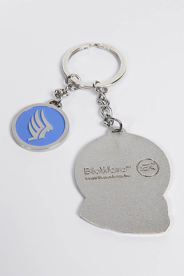  Image shows Mass Effect Morality Keychain with the Shepard charm facing back showing the Bioware and EA logos. While the 2-sided morality charm is showing the Paragon side. 