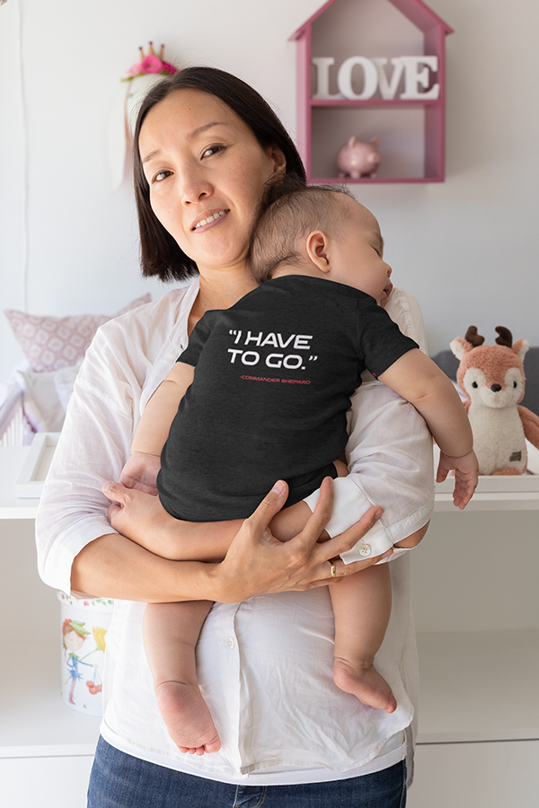 Image shows N7 I Have To Go Baby Onesie worn by baby model while sleeping on female model's chest. Product features side seam construction and double-needle ribbed binding on lap, shoulder, neck, shoulders, sleeves, and leg opening.