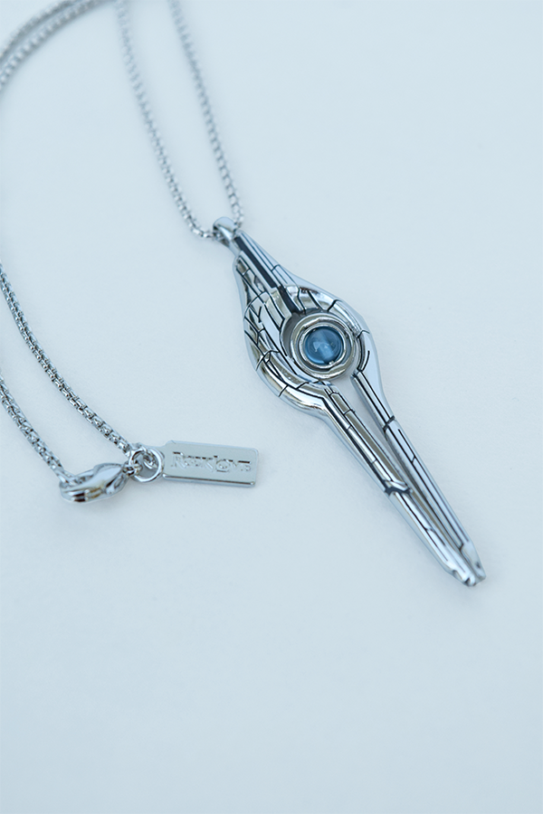 Image shows Mass Effect Mass Relay Pendant laid flat facing front.