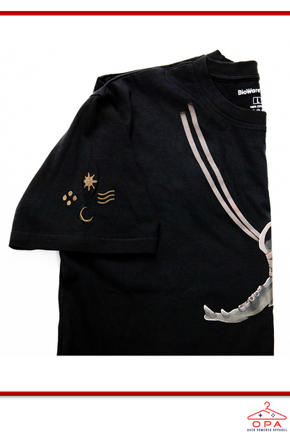 Image shows Dragon Age Solas Jawbone OPA Tee folded and laid flat. Product features an embroidery on the right sleeve,