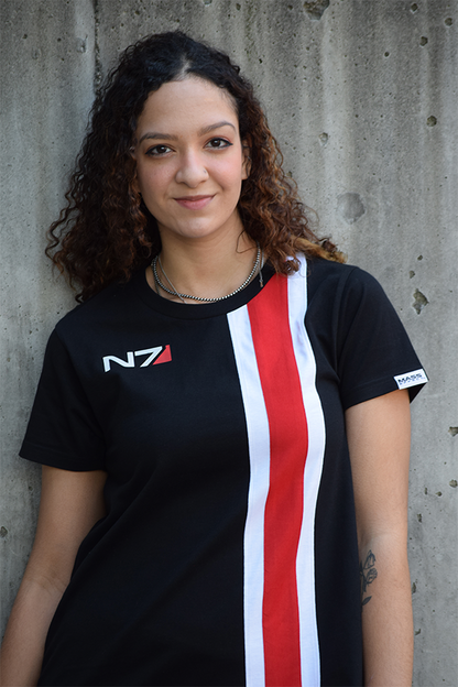 Image shows Mass Effect N7 Dress worn by female model facing front. Product highlights all features such as the N7 logo print at the front, the red and white vertical stripes, and the Mass Effect logo tag on the left sleeve.