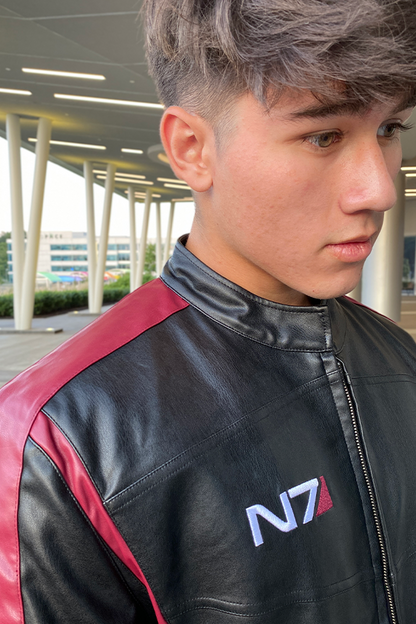 Image shows Mass Effect N7 Jacket Reimagined worn by male model while facing at a right angle. Jacket is to be hand washed cold only and dry flat. 