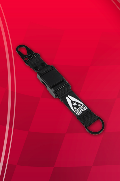 Image shows Mass Effect Normandy Auto Accessory Kit keychain facing front. Keychain has a magnetic closure and grosgrain ribbon with a anti-silver stainless steel ring.