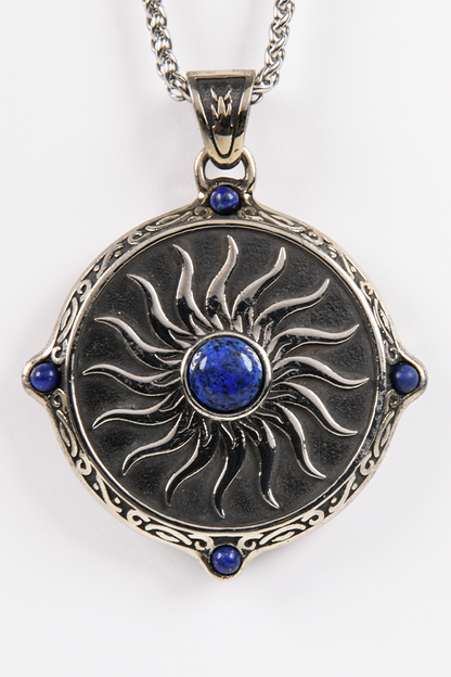 Image shows the Amulet Necklace zoomed in facing front. The amulet is from Alistair's mother with a beautiful embossed steel pendant that is decorated with 5 blue agate stones. The embossed design replicates the Chantry fire symbol to represent the purity of Andraste.