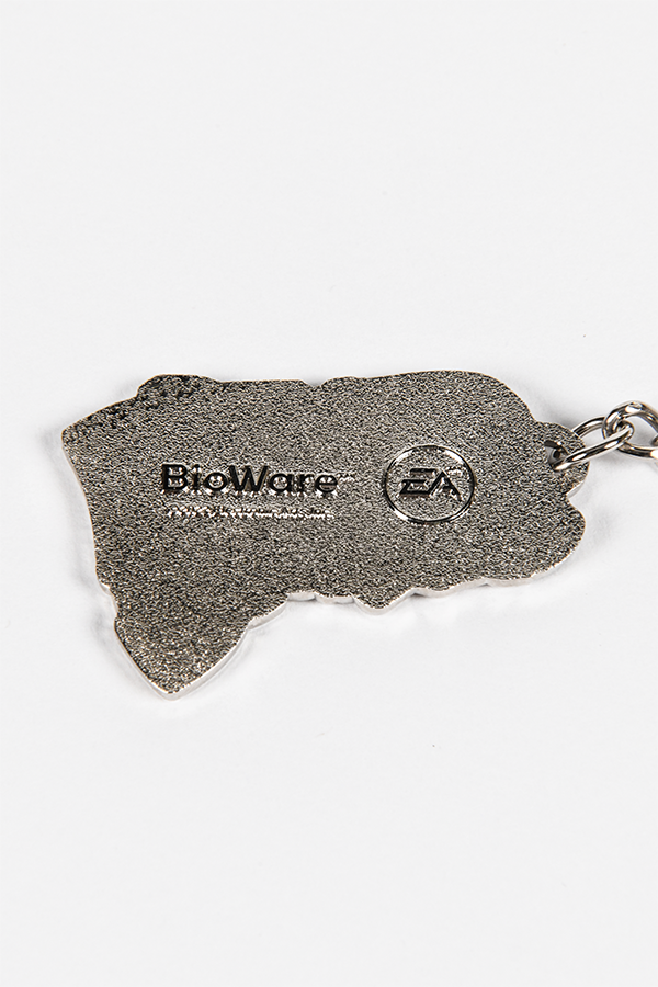 Image shows the Kaiden charm laid flat facing back. This keychain is a wonderful way to commemorate your comrade. Add it to your backpack’s zipper, your key bunch or your Mass Effect collection.