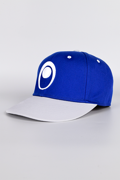 Image shows Mass Effect Blue Suns Hat facing at an angle. Product is blue with a contrasting white bill and contrast-colored eyelets and top button.