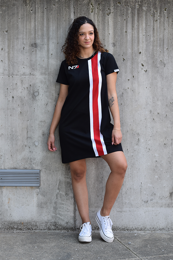 Image shows Mass Effect N7 Dress worn by female model facing at a left angle. Product is 100% cotton jersey with breathable fabric which makes it a great choice for casual parties and gatherings.