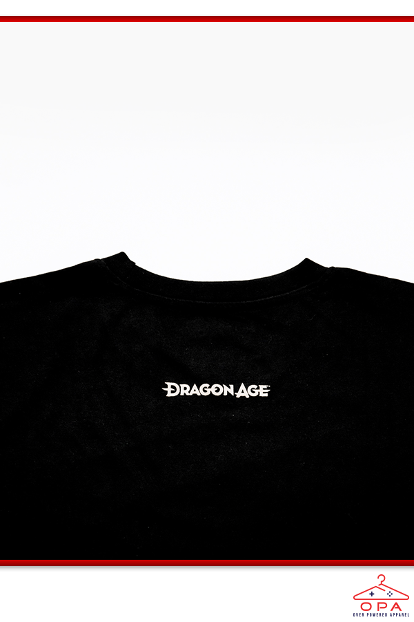 Image shows Dragon Age Solas Jawbone OPA Tee zoomed in at the back logo print. Dragon Age is a media franchise centered on a series of fantasy role-playing video games created and developed by BioWare, which have seen releases on the Xbox 360, PlayStation 3, Microsoft Windows, OS X, PlayStation 4, and Xbox One. The franchise takes place on the fictional continent Thedas, and follows the experiences of its various inhabitants.