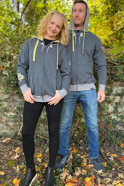 Image shows both a female and male model wearing the Dragon Age Pavus Hoodie while facing front.  Anew and full of hope, Dorian sheds his past like a snake shedding its skin and embraces his true self. This hoodie features a giant black snake screen printed at the back with embroidered white snakes on the front chest, a white snake embroidered on the hood, a coiled embroidered snake on the right sleeve, and an infinity symbol embroidered on the left sleeve.