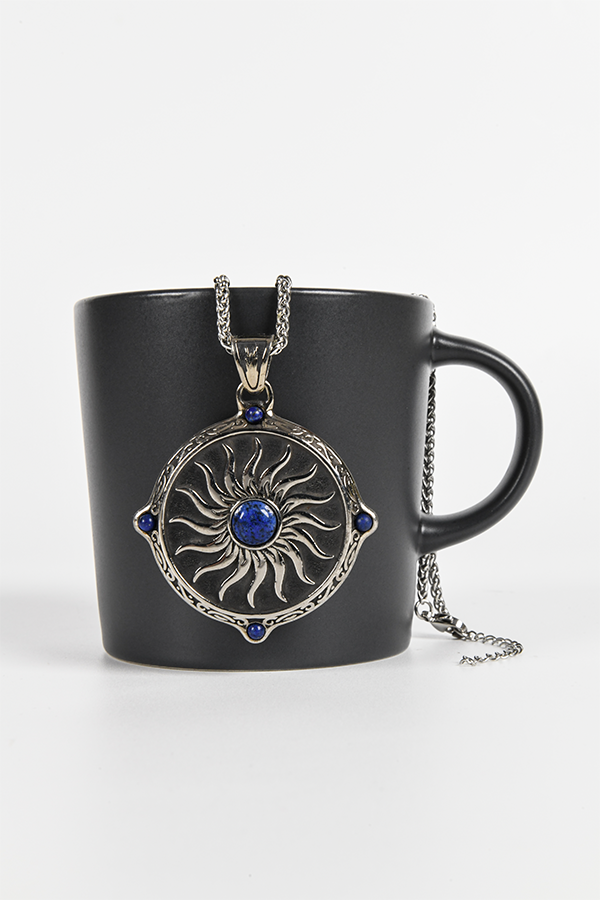 Image shows the Amulet Necklace hanging from the mouth of the mug facing front. The amulet has a 22" chain and is 3.5 mm wide with a 2" extender.