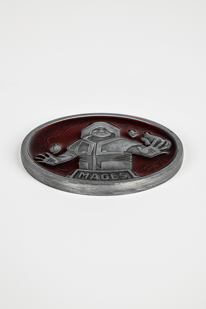 Image shows the Mage coin laid flat. Mage coin features an embossed design of a mage with a red background and vine pattern.