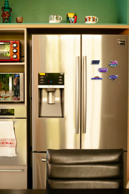 Image shows Mass Effect Nightlife Magnet Set with all 5 magnets sticking on the right side of a fridge.