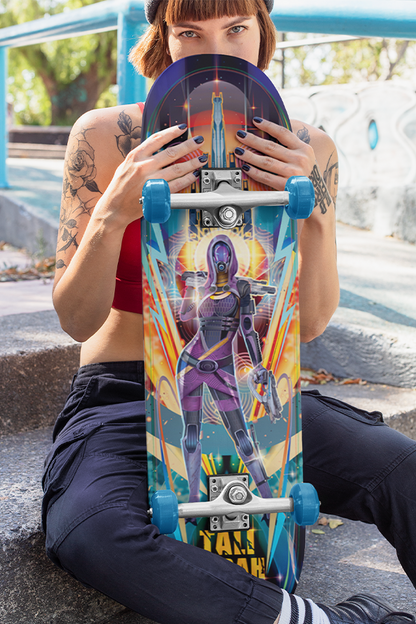  Image shows Mass Effect Tali Zorah Skate Deck held upright by sitting female model with the deck facing front. Product features a colorful fade-proof printing and artist's signature.