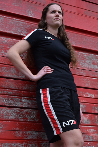 Image shows Mass Effect N7 Active Shorts worn by female model facing at an angle. Product features a back pocket with zip closure. 