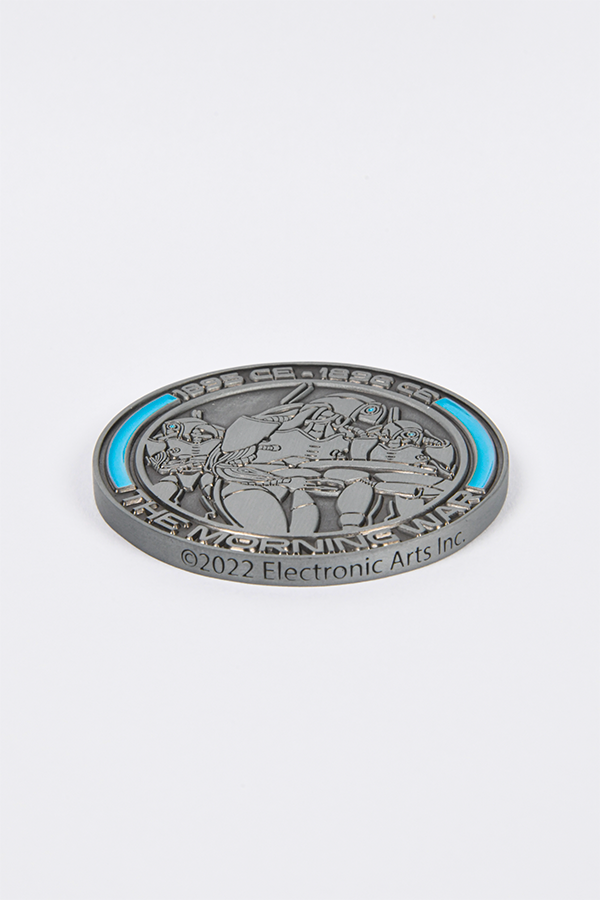 Image shows Mass Effect Morning War Challenge Coin laid flat. the side shows an inscription of "2022 Electronic Arts Inc."