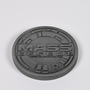 Image shows Mass Effect Coin Album's coin laid flat facing back. The back of the coin features the Mass Effect logo.