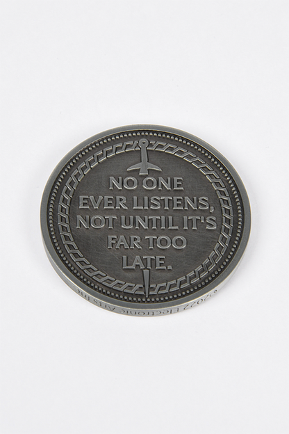 Image shows Dragon Agree Advisors Coin Set with one coin laid flat facing back with the text that reads "No one ever listens not until it's far too late."