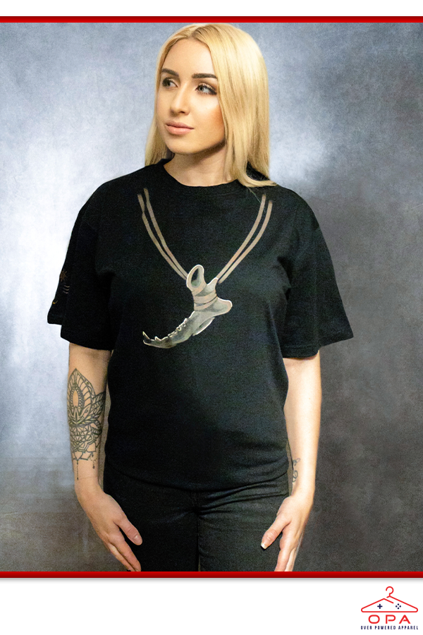 Image shows Dragon Age Solas Jawbone OPA Tee worn by a female model facing front. Solas is an elven apostate hedge mage and an expert on the Fade. He is a companion and a romance option for a female elven Inquisitor in Dragon Age: Inquisition.