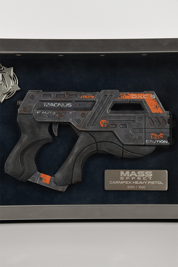 Image shows Mass Effect Carnifex Replica Shadowbox facing front zoomed in at the M-6 Carnifex pistol. The pistol is hand-painted and 8" long made with polyresin. 