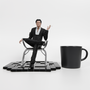 Image shows Illusive Man Statue sitting next to a black coffee mug. Product is 22cm in length, 20cm in width and 21.8cm in height.