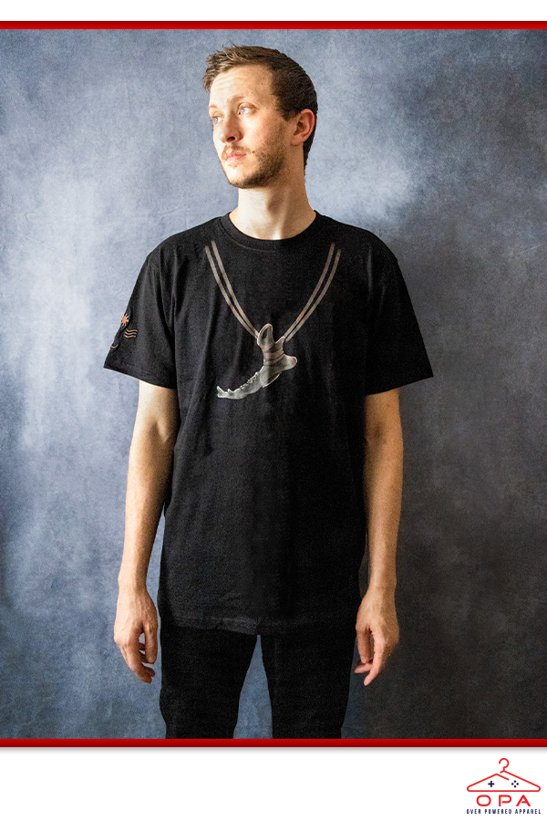 Image shows Dragon Age Solas Jawbone OPA Tee worn by a male model facing front. Solas grew up in a small village. Before the events that led to the formation of the Inquisition, he spent most of his life wandering the wilderness, and although his pointed ears mark him as one of the Elvhen, he does not recognize himself as a Dalish or a city elf.