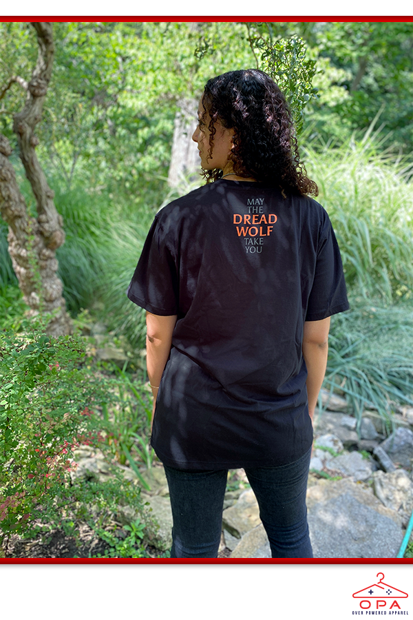 Image shows Dragon Age Dread Wolf OPA Tee worn by female model facing back. Product has side seams and shoulder seams with a set-in sleeve.