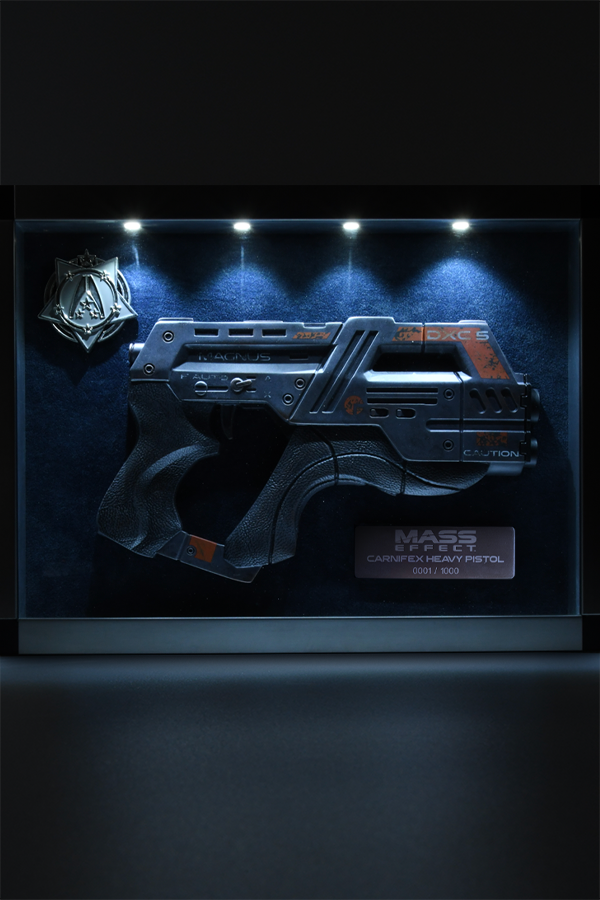 Image shows Mass Effect Carnifex Replica Shadowbox lit up facing front. The Carnifex is a favored sidearm of mercenary leaders and Eclipse mercenary tech specialists. An expensive but powerful weapon. Its marketing materials feature a charging krogan with the slogan "Don't you wish Carnifex was at your side?"